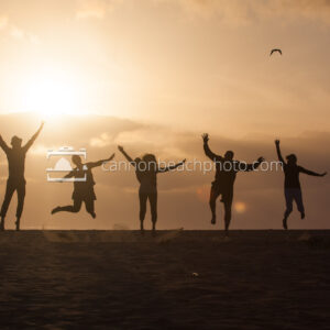 Silhouetted Family Jumping on the Beach 1