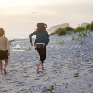 Two Young Women Running on the Beach